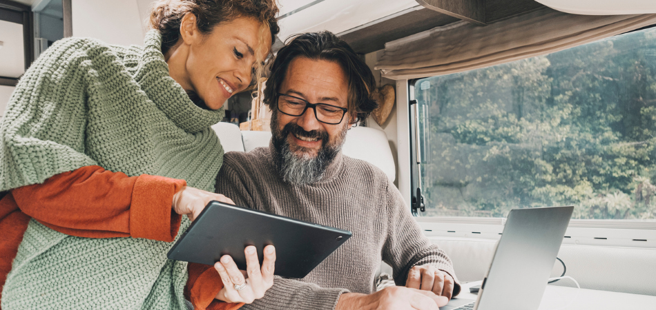 A couple looking at booking a campsite for the season ahead and getting ready for the RV season.