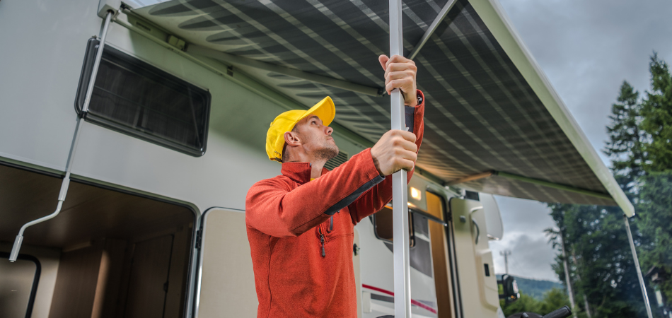 A person taking down their RV awning before a storm.  