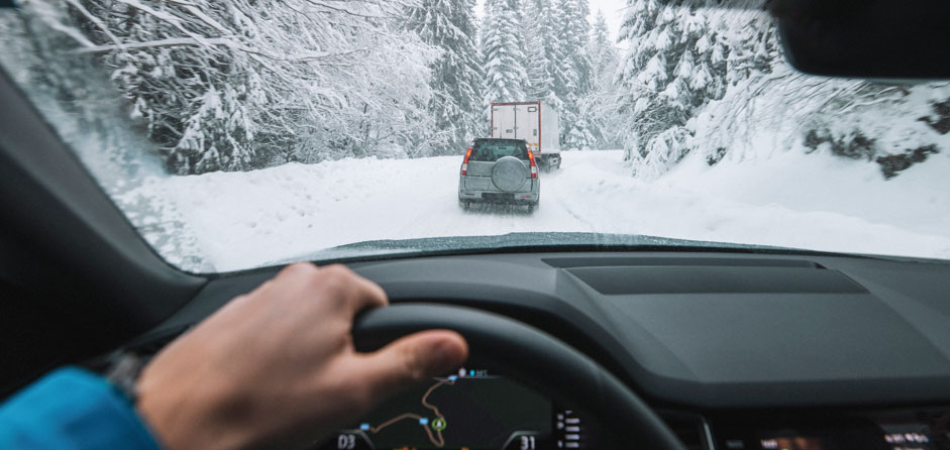 A man driving in winter conditions.