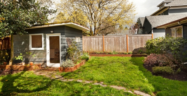 Photo of a shed in the backyard of a home property. 