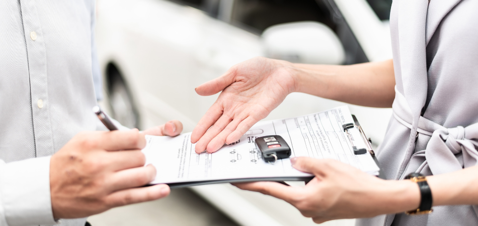 A new driver reviewing auto insurance information before getting behind the wheel of a vehicle.  