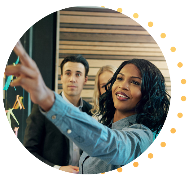 A Black woman is leading her colleagues as they workshop ideas. 