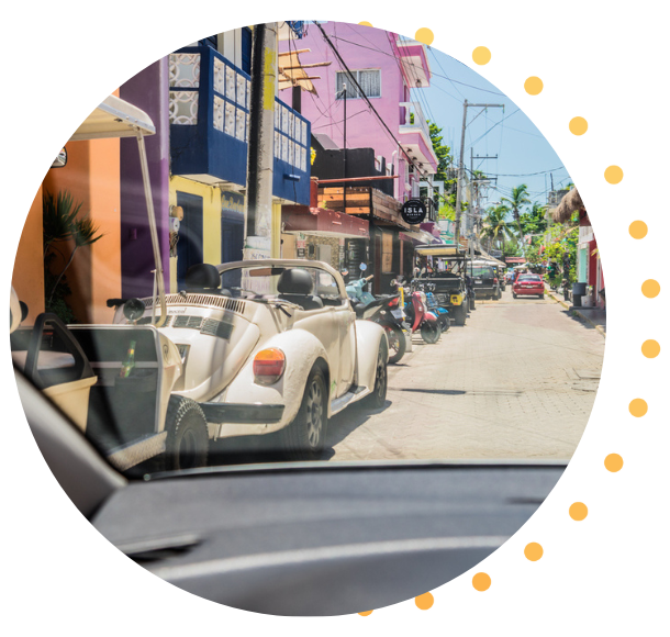 View through the windshield of a car driving through the streets of Mexico. 