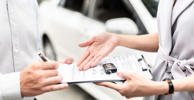 A new driver reviewing auto insurance information before getting behind the wheel of a vehicle.  