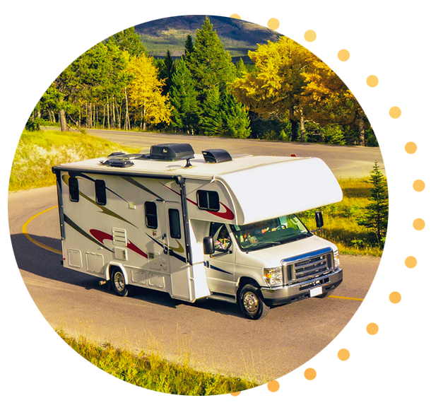 An RV driving up a hill on a sunny day