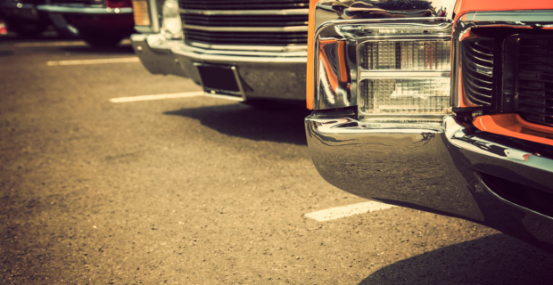 Close-up view of classic cars from the 70s parked in a row.  