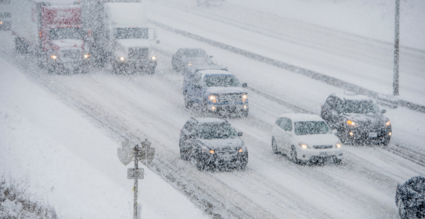 Vehicles driving in a winter storm.