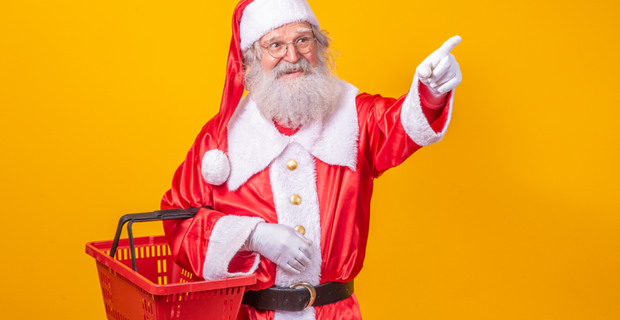 Santa Claus holding a basket wearing a red and white suit 