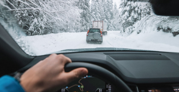 A man driving in winter conditions.